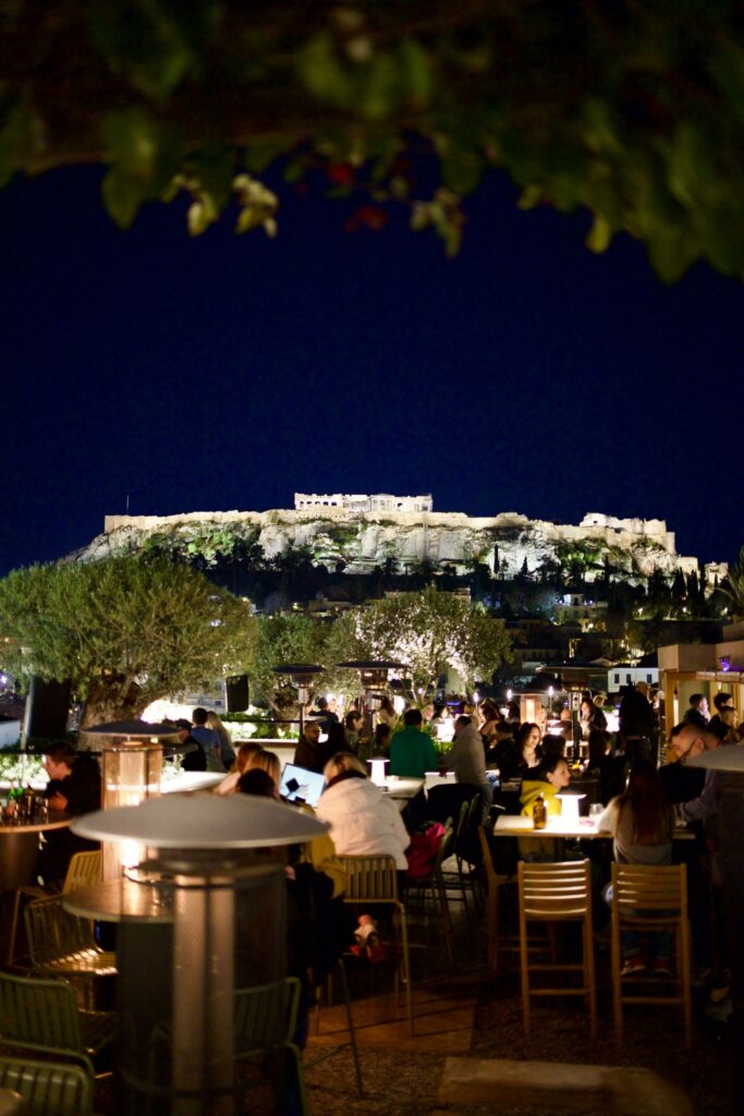 A Greek restaurant looks out to the top of ruins, Greece